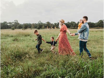 2 adults and 3 children in a field 